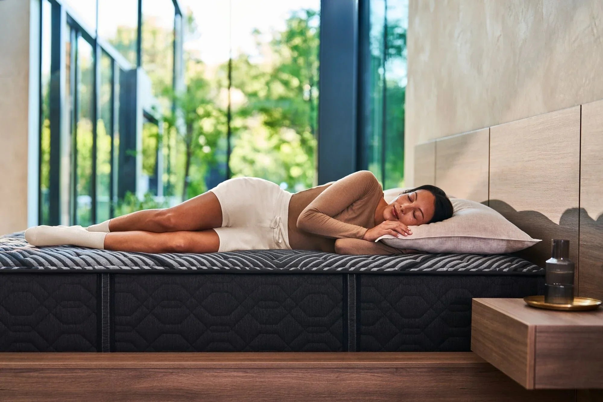 Woman laying on her left side asleep on a Beautyrest mattress