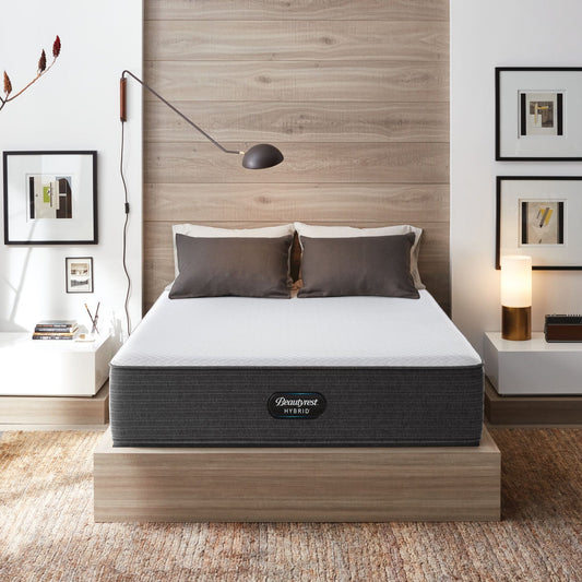 The Beautyrest Select hybrid mattress in a bedroom on a wooden bed||feel: Firm