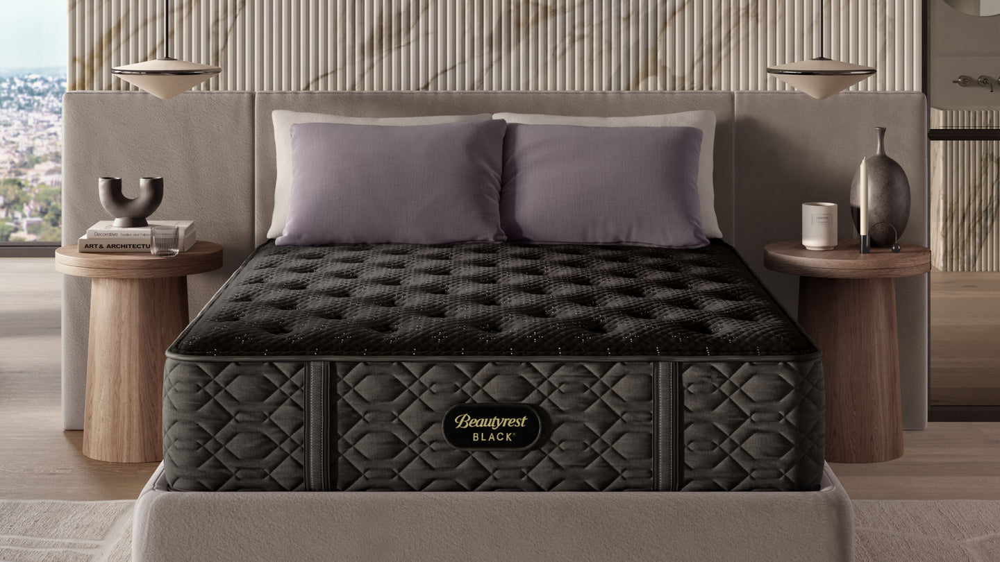 Beautyrest Black mattress sitting in a beige bedframe.  There are 4 pillows on top of it.