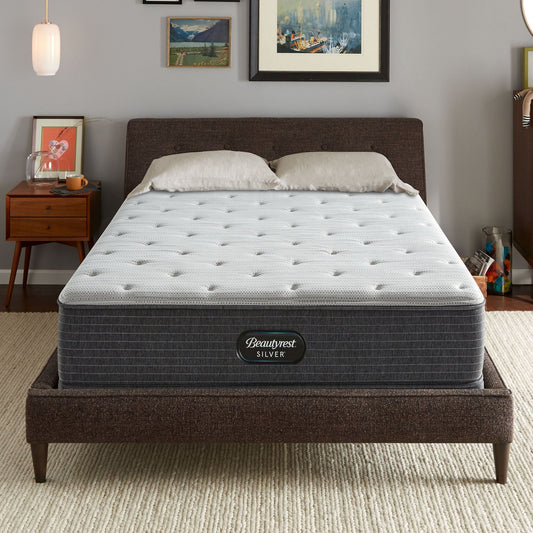 The Beautyrest Silver BRS900 Medium Firm mattress in a bedroom on a brown bed