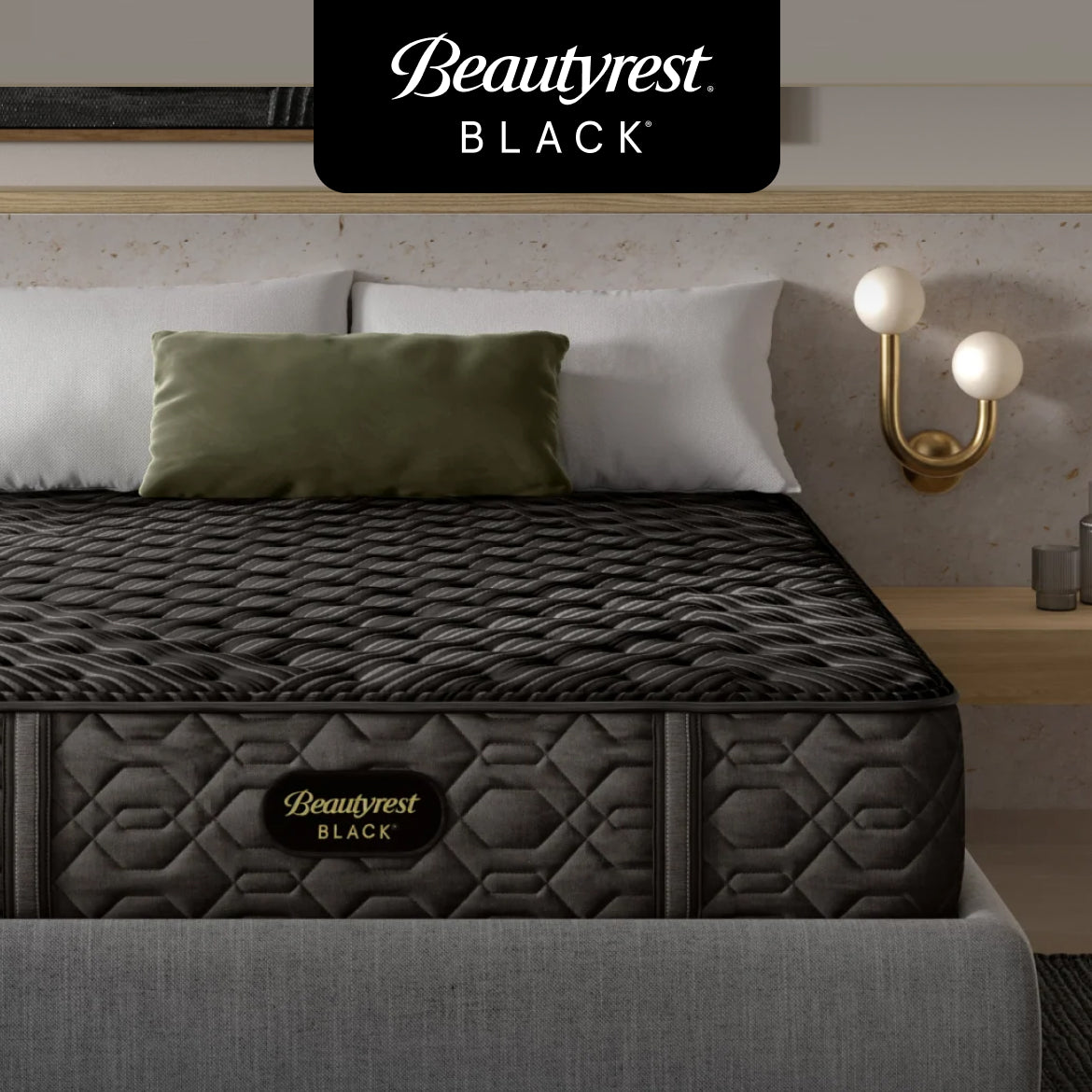 A Beautyrest Black mattress with a quilted black surface and a grey upholstered bed frame, styled with white and green pillows, featuring advanced temperature management and luxurious support.