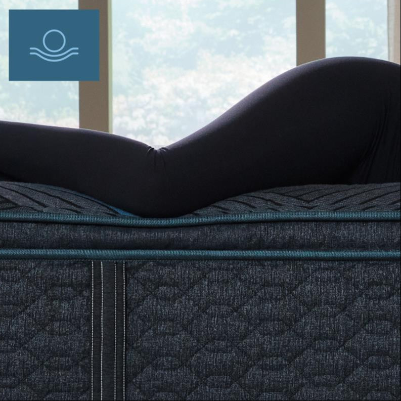 Woman laying on her left side on top of a Beautyrest Hybrid mattress