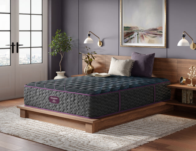 Beautyrest World Class Quilted Level 3 mattress with 2 pillows and a book on top of it sitting on a brown bed frame