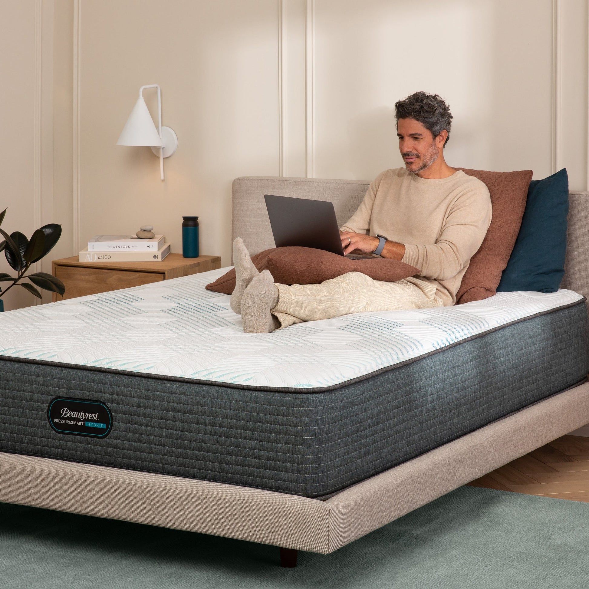 Man working on his laptop on the Beautyrest PressureSmart mattress||feel: firm||series: hybrid