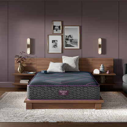 Beautyrest World Class Quilted Hybrid mattress sitting in a brown bed frame with 2 pillows on top of it