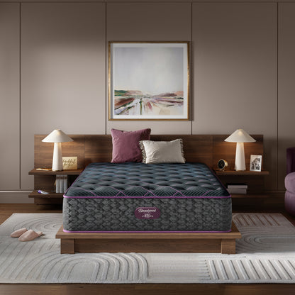 Beautyrest World Class mattress sitting in a brown bed frame with 2 pillows on top of it